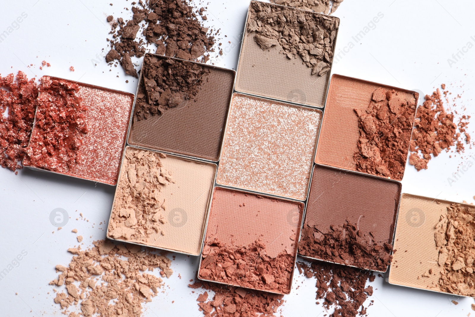 Photo of Crushed eye shadows on white background, top view. Professional makeup product