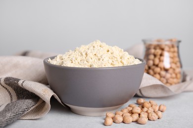 Photo of Chickpea flour in bowl and seeds on light grey table