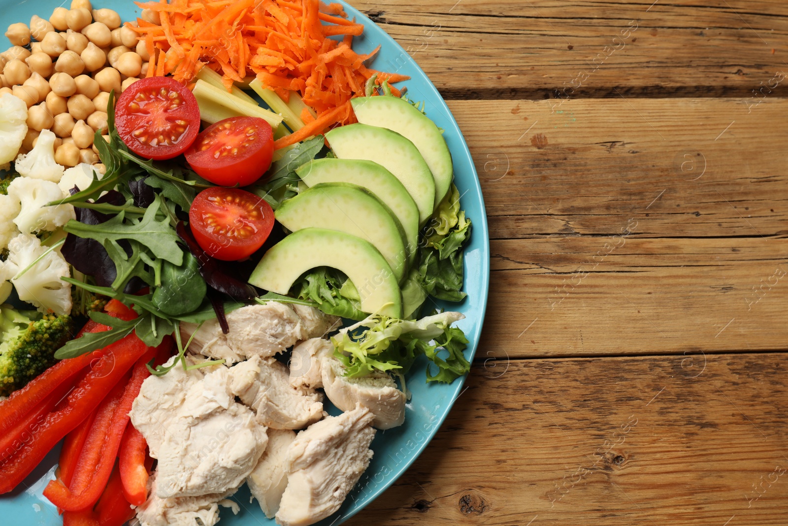 Photo of Balanced diet and healthy foods. Plate with different delicious products on wooden table, top view. Space for text