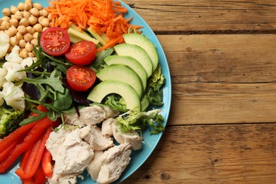 Photo of Balanced diet and healthy foods. Plate with different delicious products on wooden table, top view. Space for text