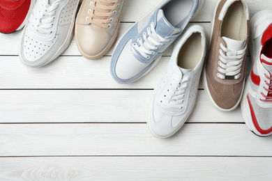 Photo of Flat lay composition with stylish shoes on white wooden table. Space for text