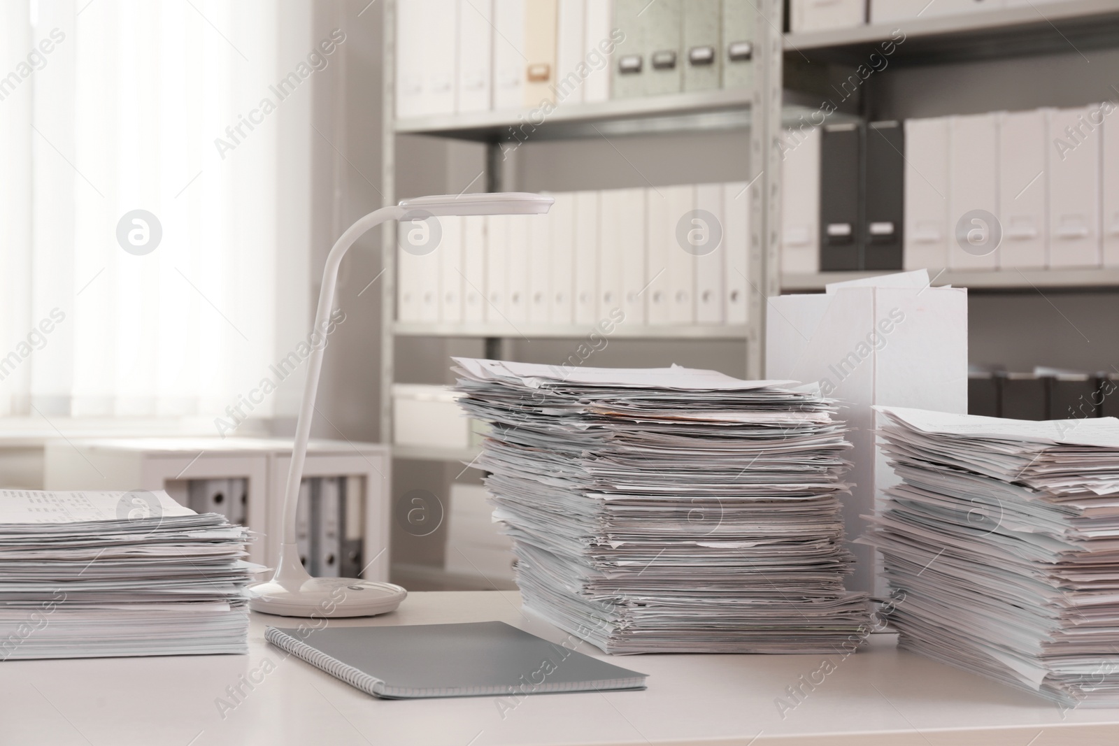 Photo of Stacks of documents on table in office