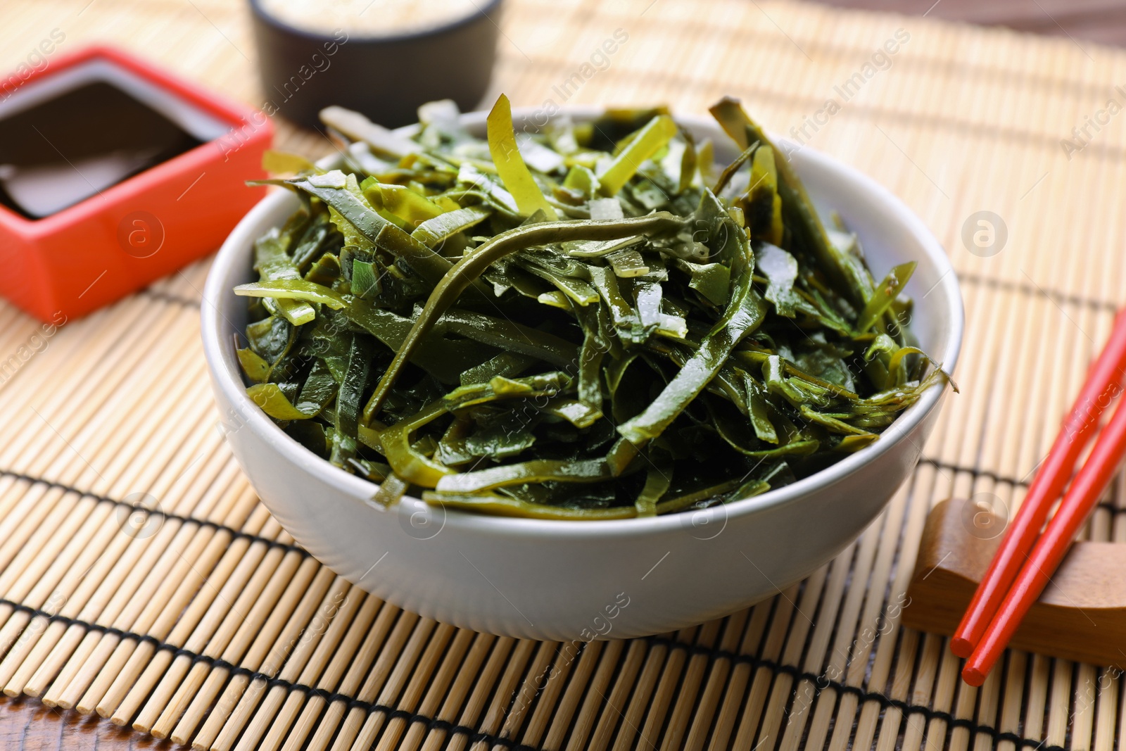 Photo of Fresh laminaria (kelp) seaweed served on wooden table