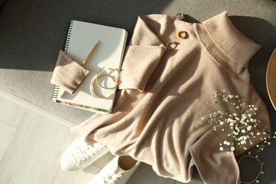 Photo of Soft cashmere sweater and accessories on sofa, flat lay