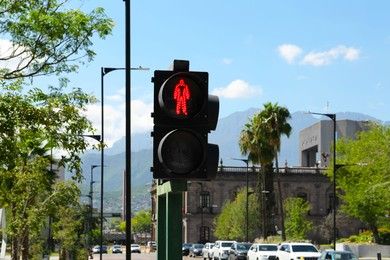 Photo of Traffic light on city street. Road rules