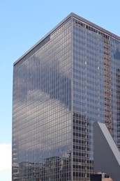 Photo of Skyscraper in city center on sunny day. Modern architectural design