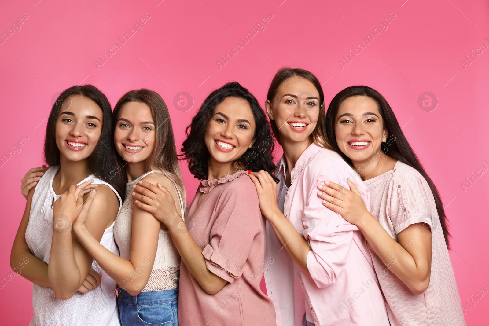 Photo of Happy women on pink background. Girl power concept