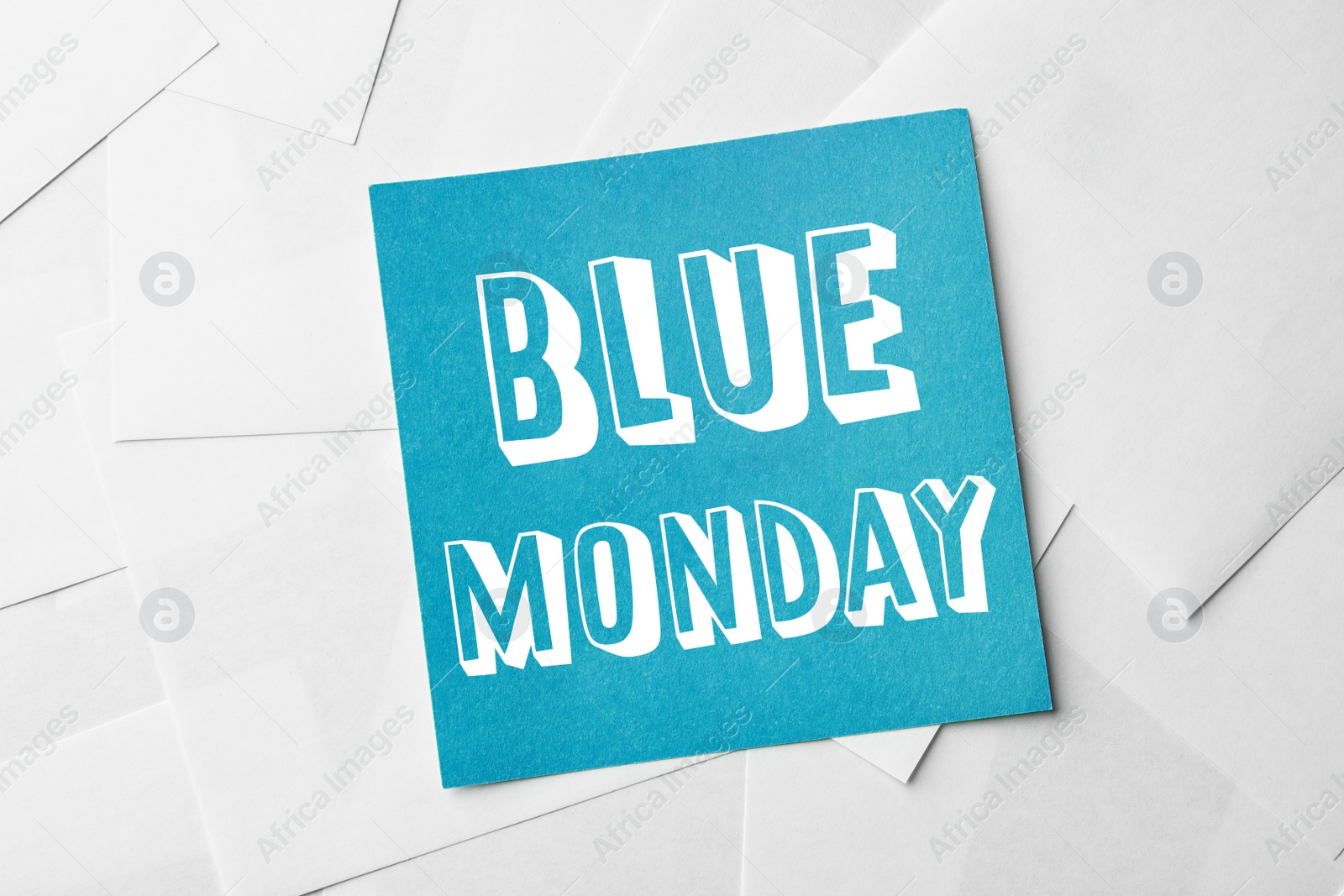 Image of Note with phrase Blue Monday on paper sheets, top view