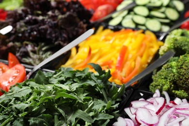 Salad bar with different fresh ingredients as background, closeup