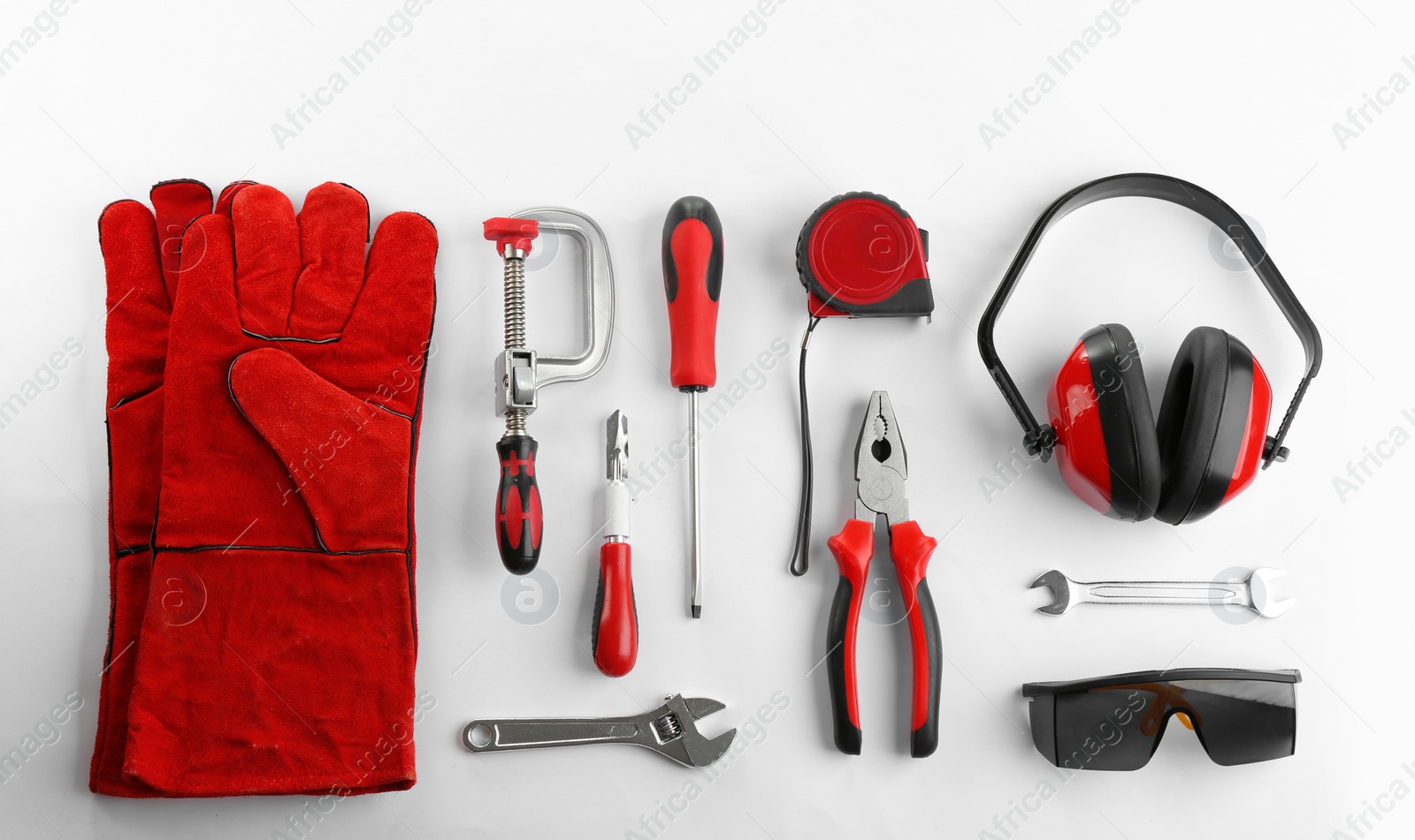 Photo of Flat lay composition with construction tools and safety equipment on white background