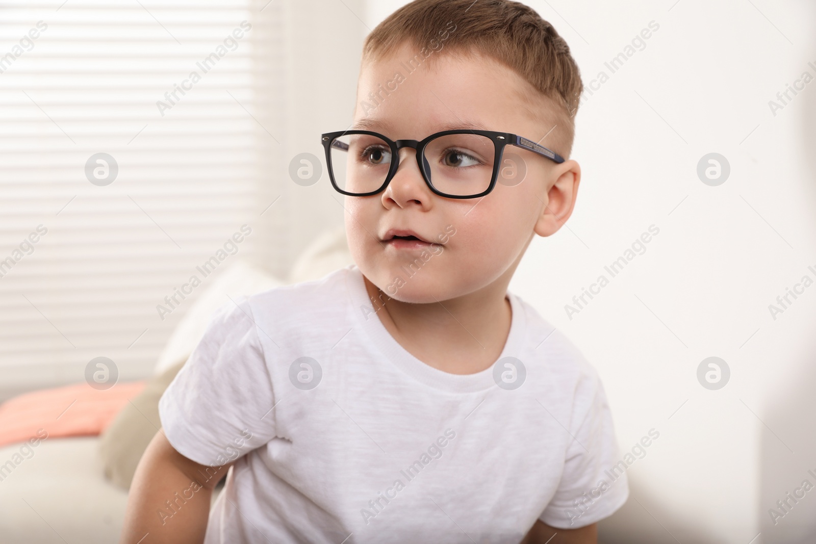 Photo of Cute little boy in glasses at home