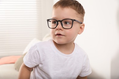 Cute little boy in glasses at home