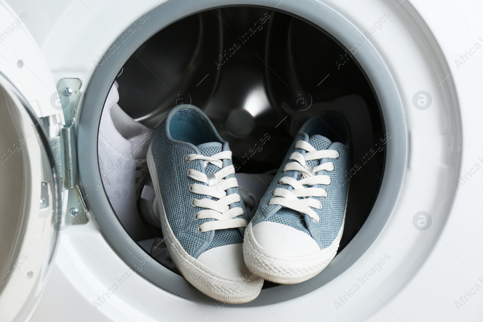 Photo of Clean sports shoes in washing machine drum