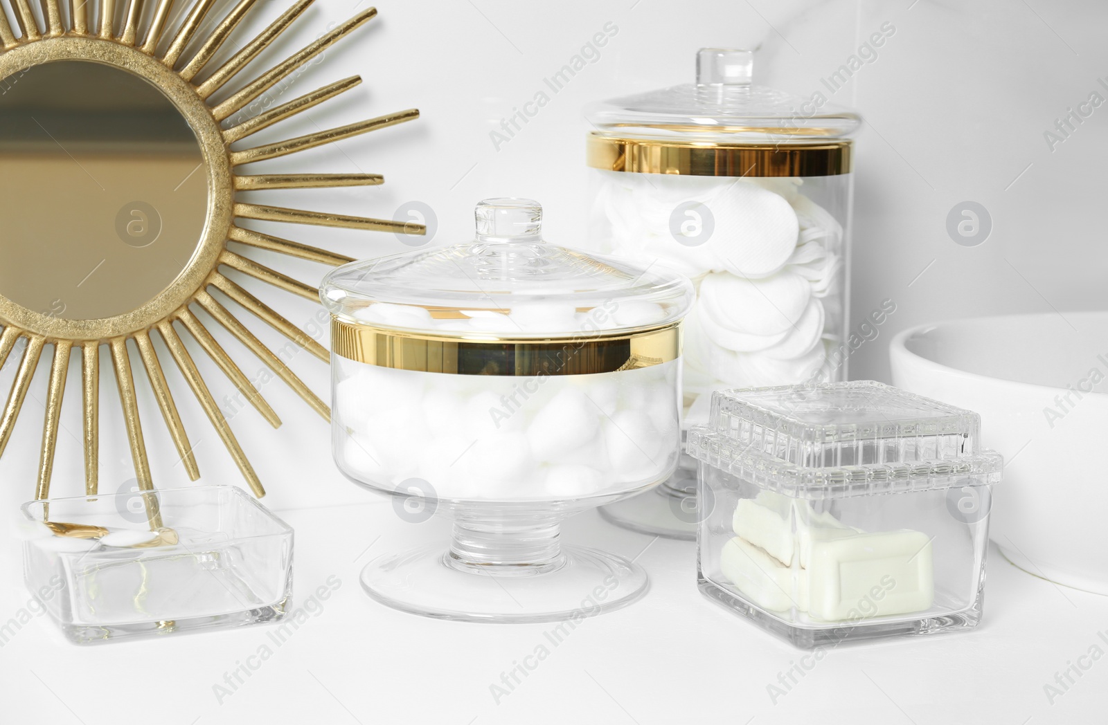 Photo of Composition with cotton balls and pads on white countertop in bathroom