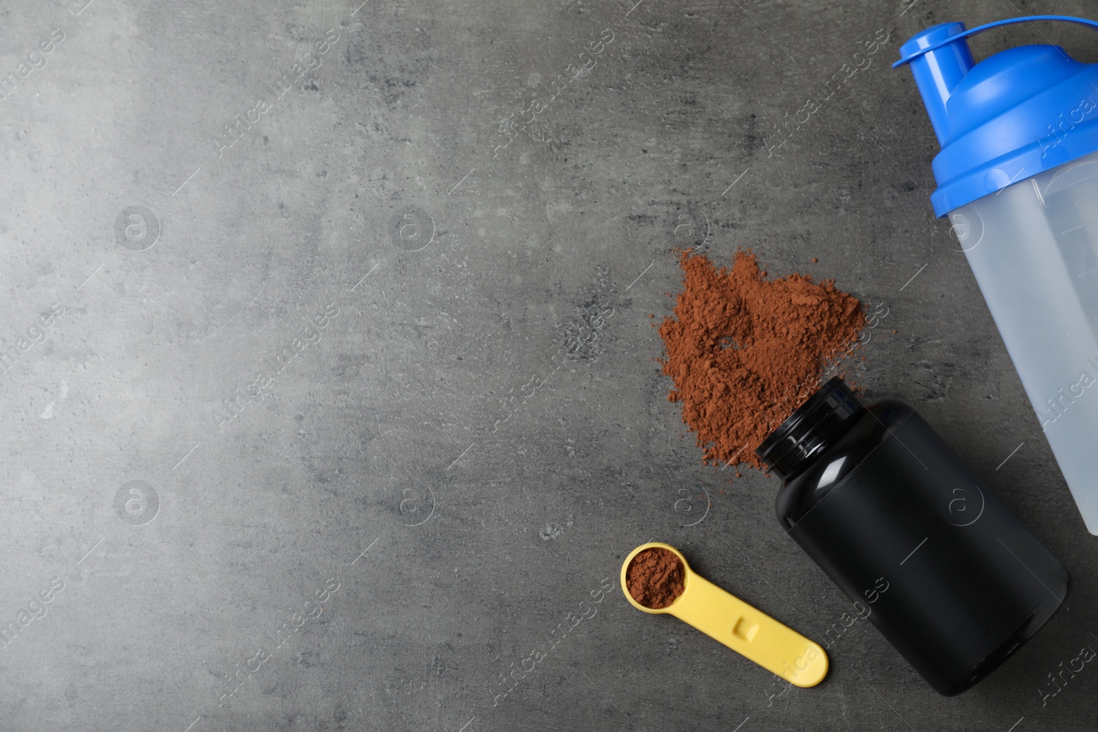 Photo of Flat lay composition with protein powder on grey table, space for text