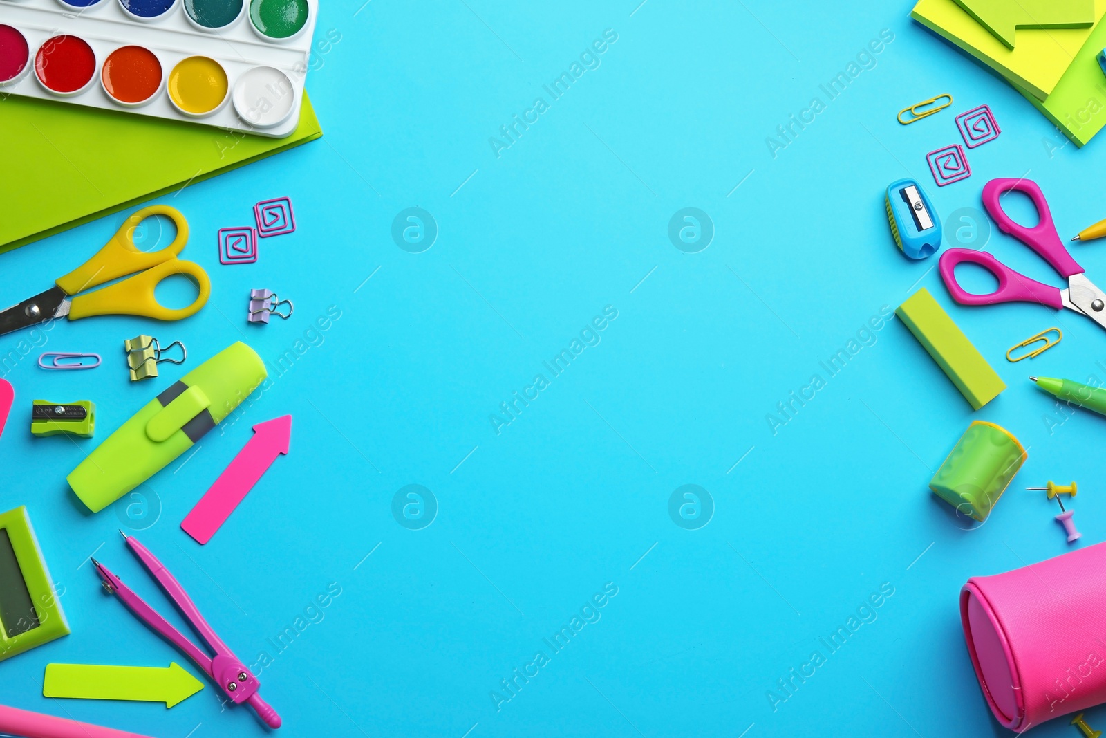 Photo of Frame made with colorful school stationery on light blue background, flat lay. Space for text