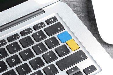 Image of Button in colors of Ukrainian flag on keyboard, closeup view