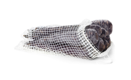 Photo of Raw black carrots in mesh bag isolated on white