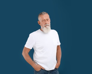 Photo of Portrait of handsome senior man on blue background