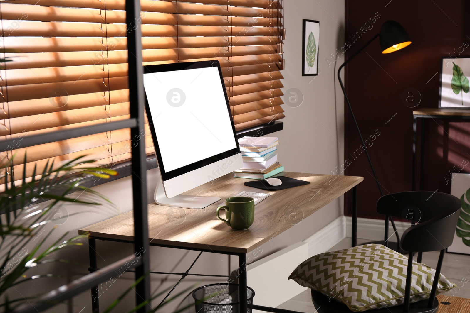 Photo of Comfortable workplace with modern computer and stylish furniture in room. Interior design