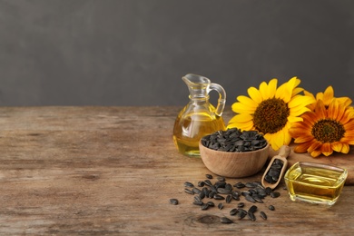 Photo of Composition with sunflower oil on wooden table, space for text