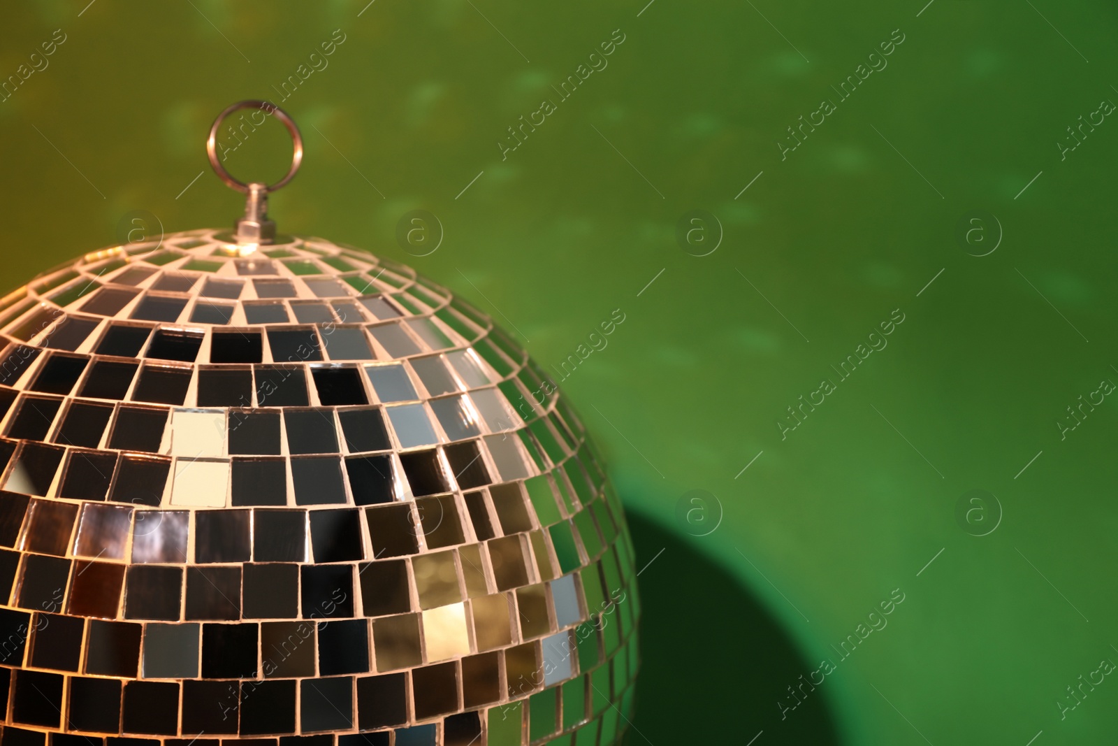 Photo of Shiny disco ball on color background, closeup. Space for text