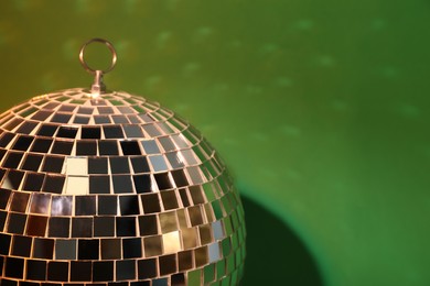 Shiny disco ball on color background, closeup. Space for text