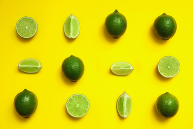 Photo of Flat lay composition with fresh juicy limes on yellow background