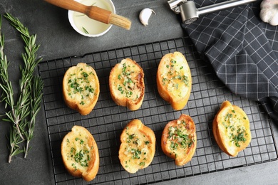 Flat lay composition with tasty homemade garlic bread on table