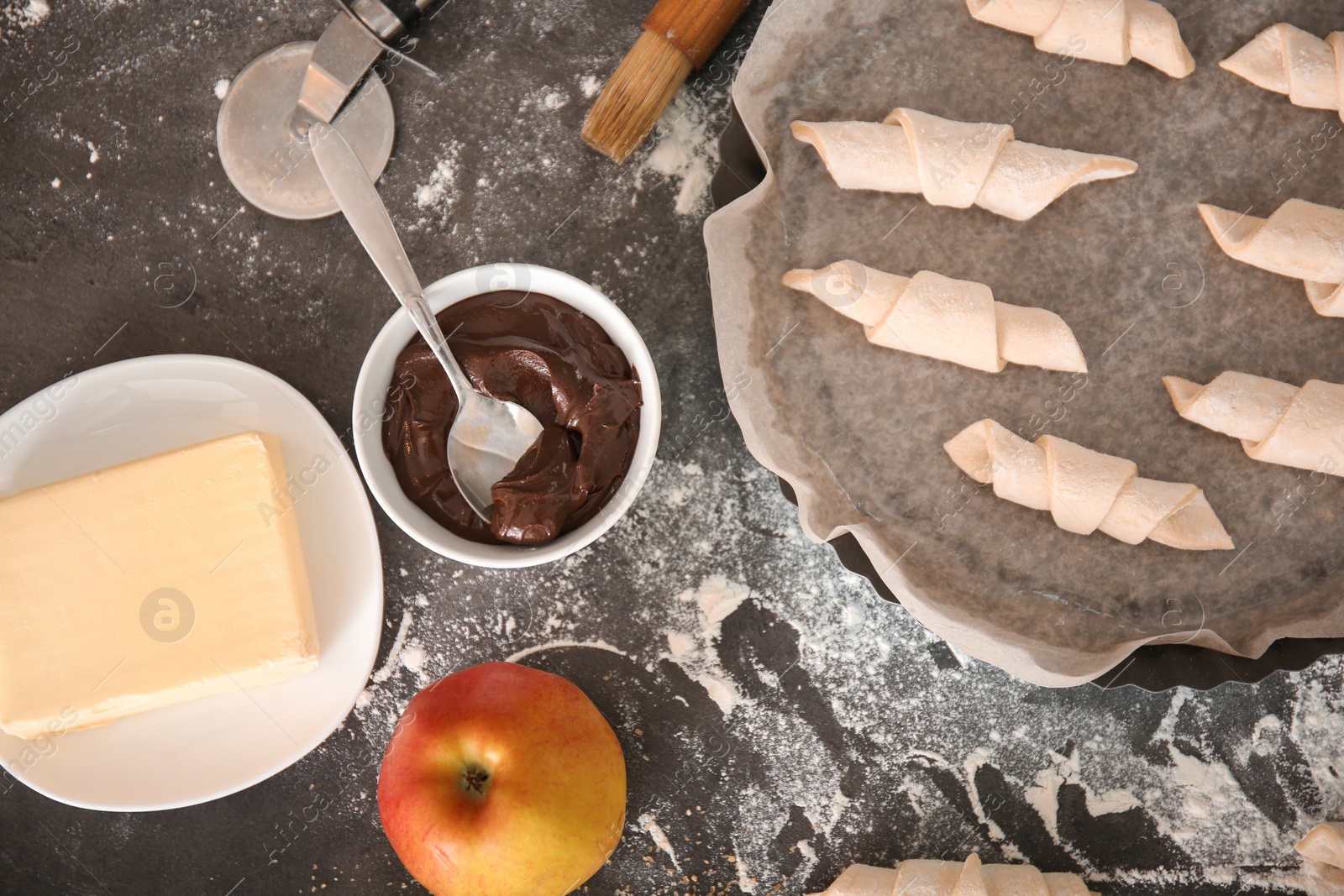 Photo of Flat lay composition with ingredients and raw croissants on grey background