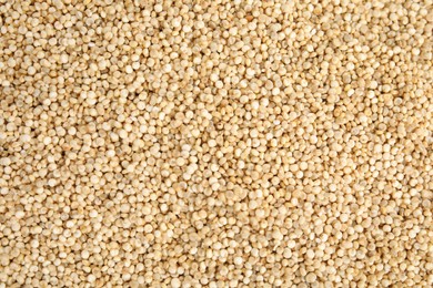 Uncooked white quinoa as background, top view