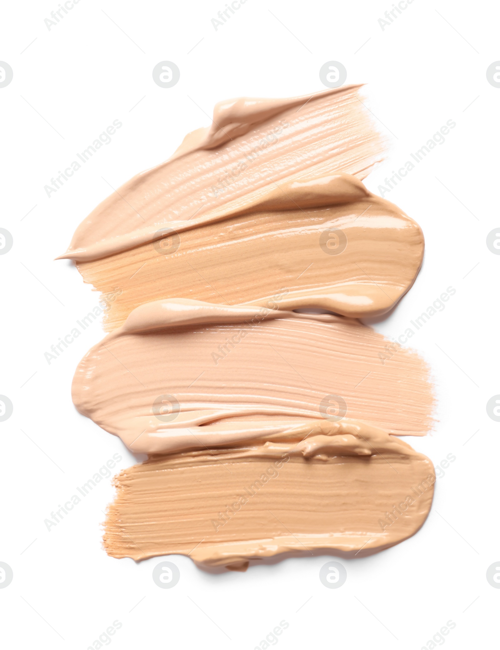 Photo of Samples of skin foundation on white background, top view