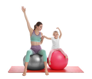 Photo of Young woman and her daughter doing exercise isolated on white. Home fitness