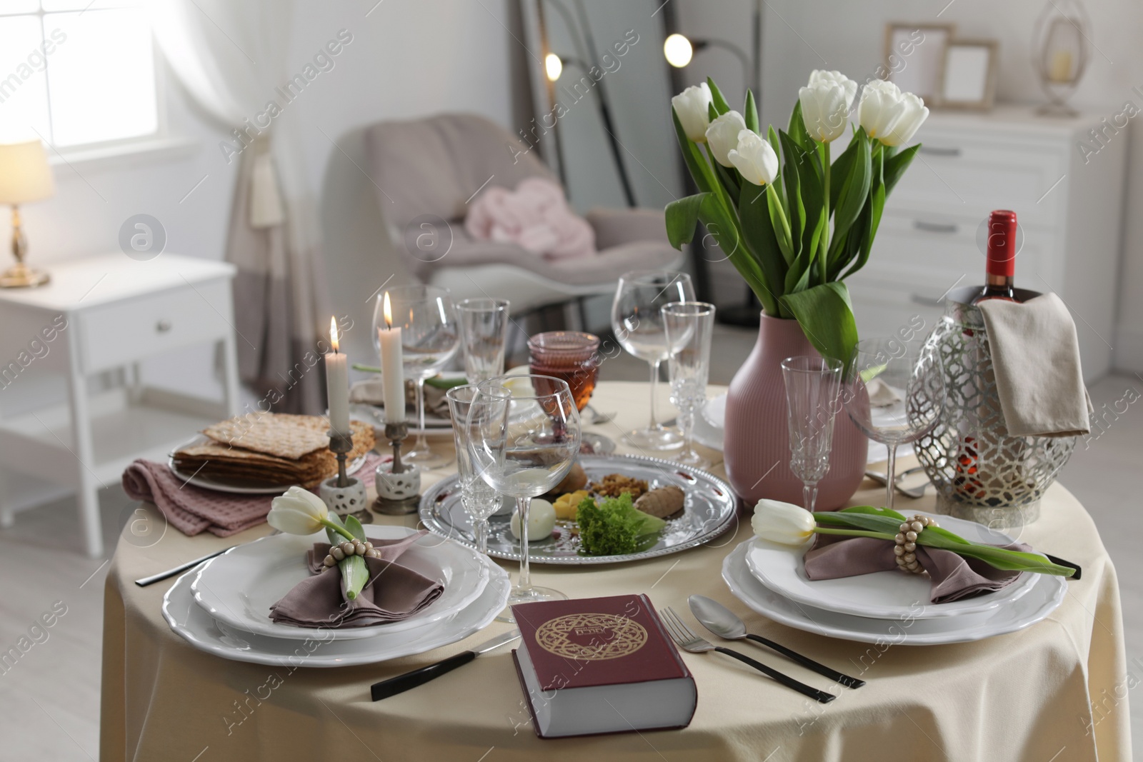 Photo of Festive Passover table setting with Torah at home. Pesach celebration