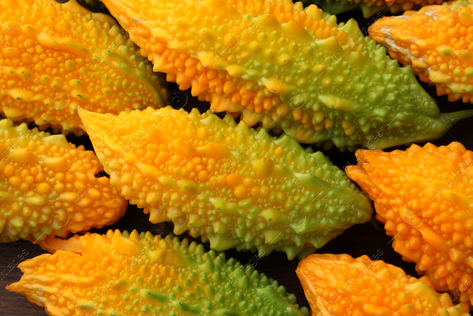 Photo of Tasty fresh bitter melons on table, closeup