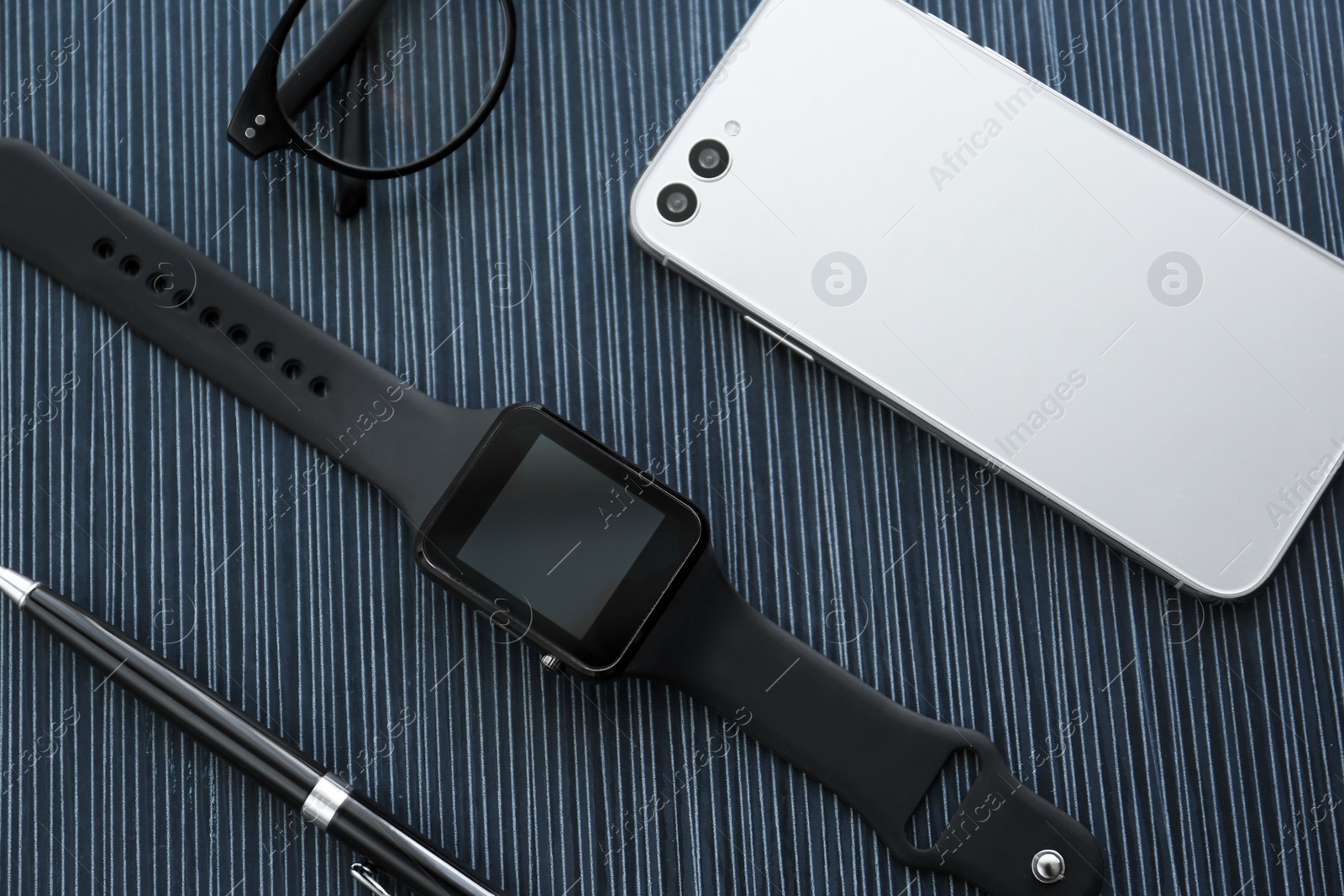 Flat lay composition with stylish smart watch on black table Photo of Flat lay composition with stylish smart watch on black table