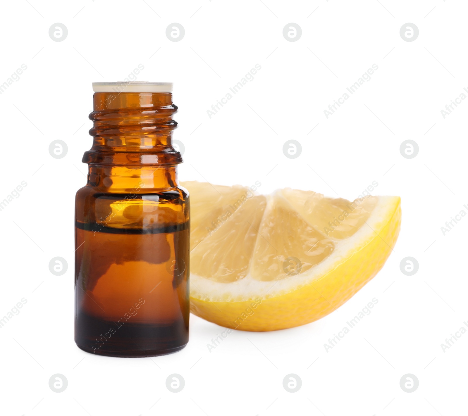 Photo of Bottle of citrus essential oil and cut fresh lemon isolated on white