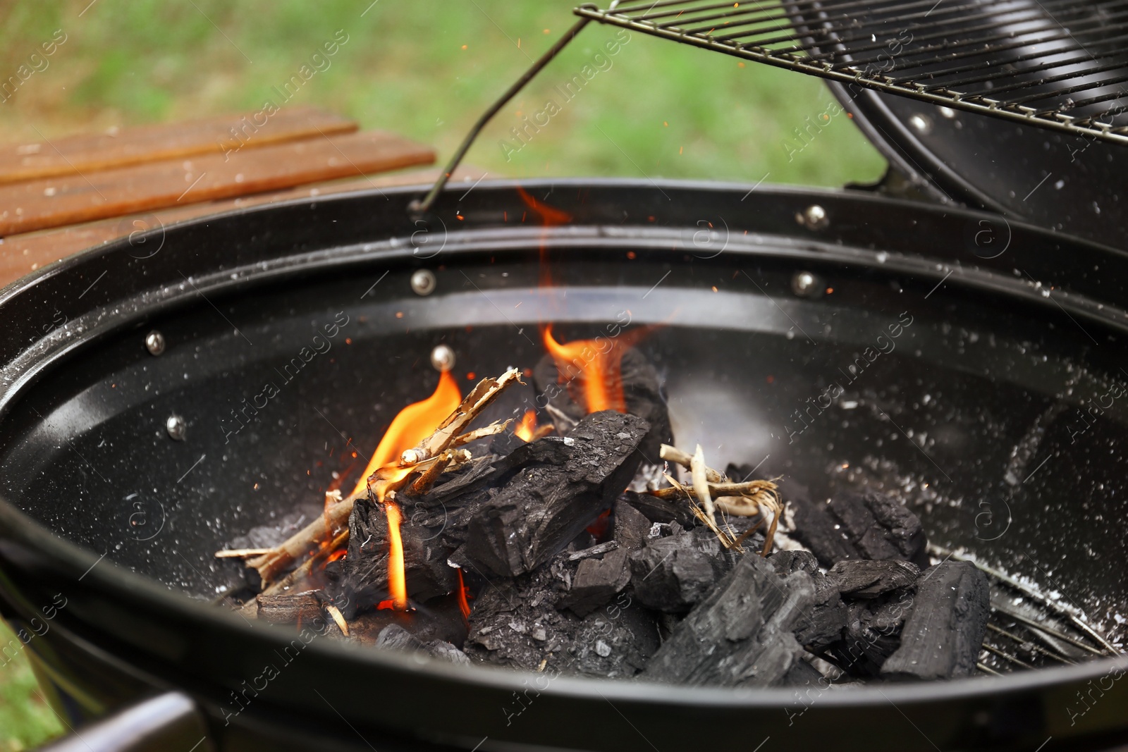 Photo of New modern barbecue grill outdoors, closeup. Summer picnic