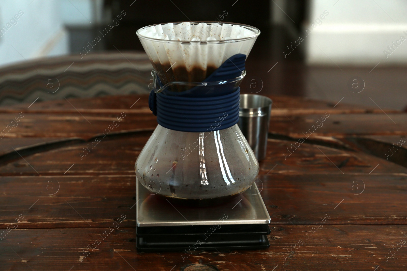 Photo of Cup with wave dripper and coffee on wooden table in cafe