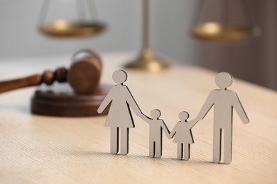 Photo of Family law. Figure of parents with children and gavel on wooden table