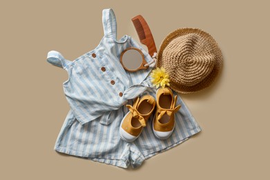 Photo of Stylish child clothes, shoes and accessories on beige background, flat lay