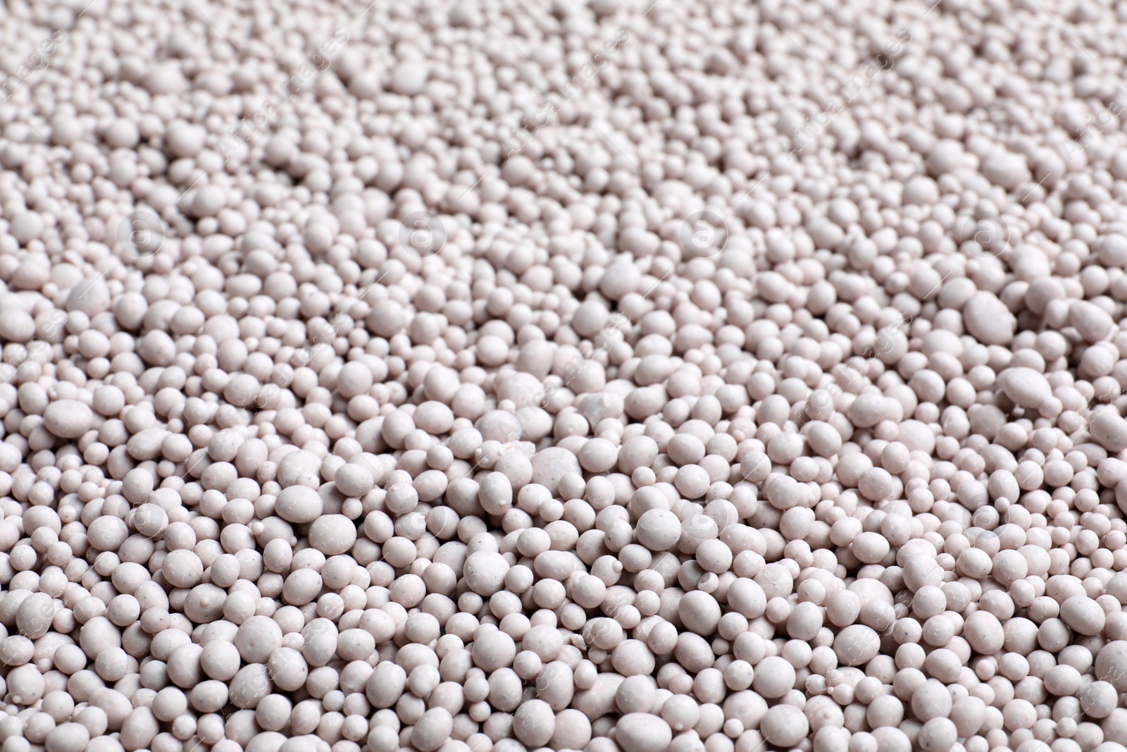 Photo of Textured chemical fertilizer for gardening as background, closeup