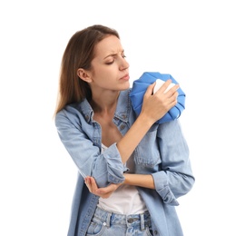 Woman applying cold compress to relieve shoulder pain on white background