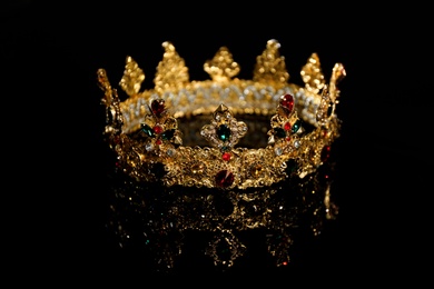 Photo of Beautiful golden crown on black background. Fantasy item