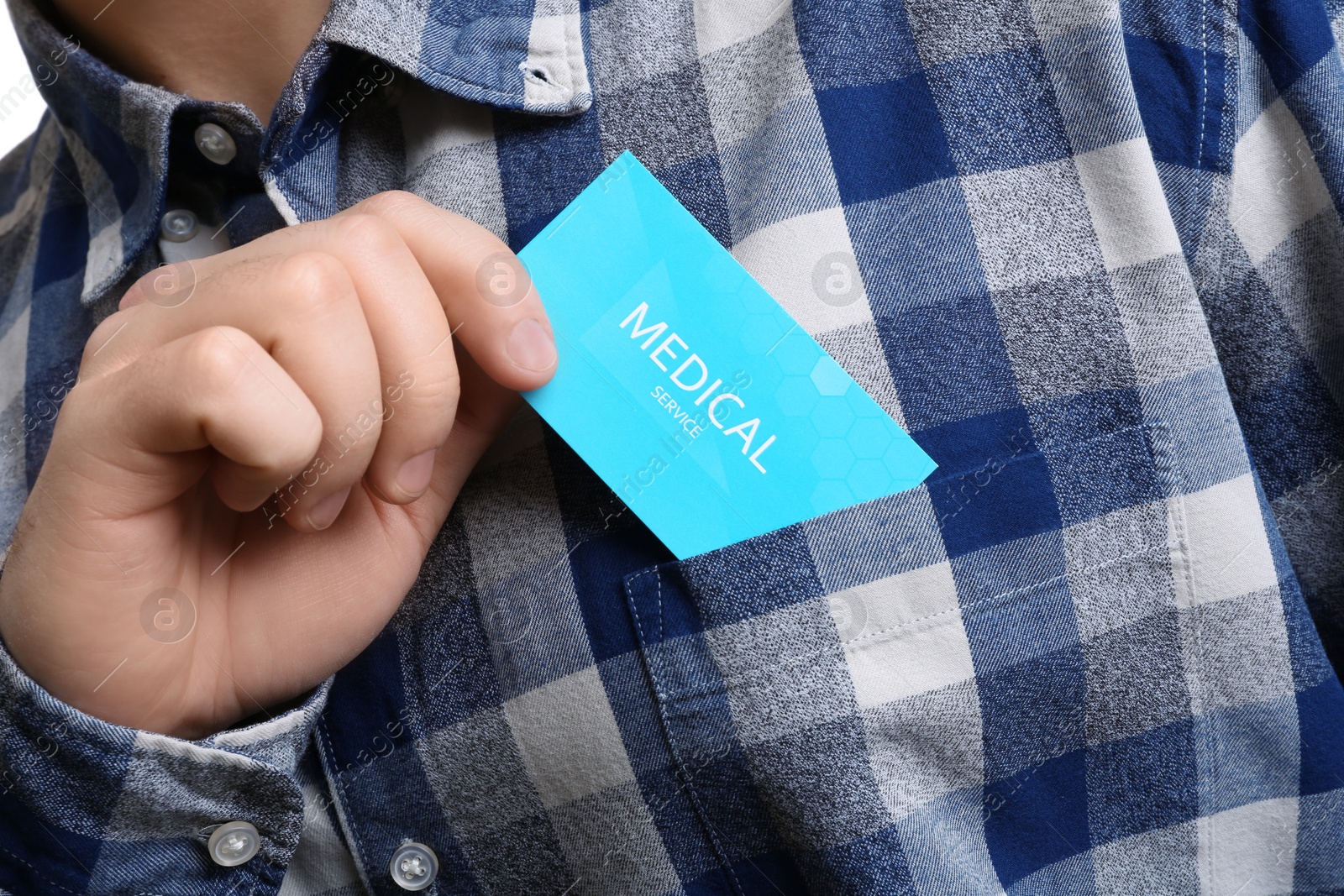 Photo of Man putting business card into pocket, closeup. Medical service