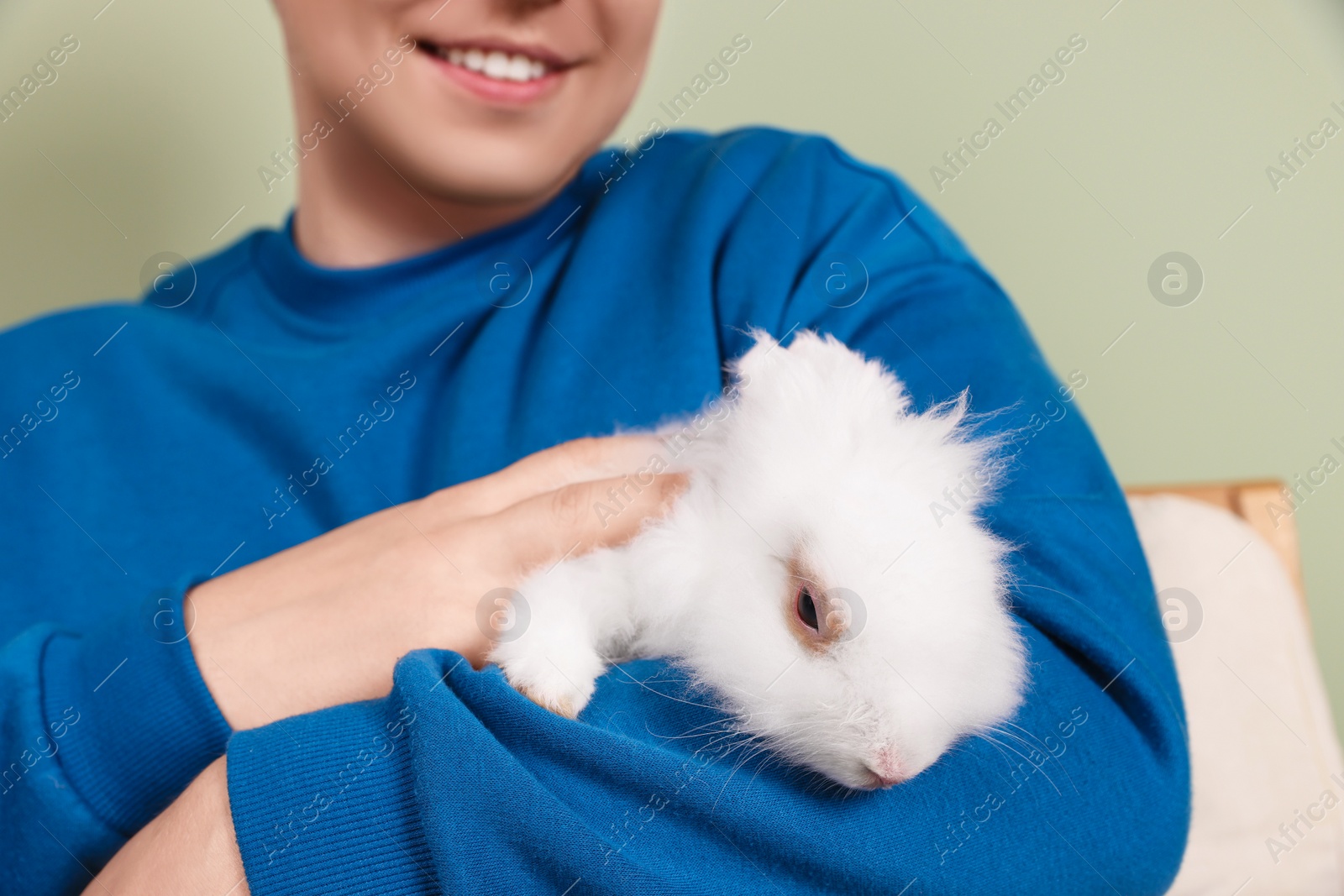 Photo of Man with fluffy white rabbit, closeup. Cute pet