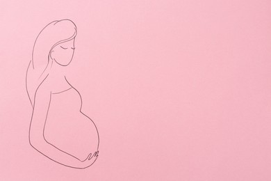 Photo of Pregnant woman figure drawn on pink background, top view with space for text. Surrogacy concept