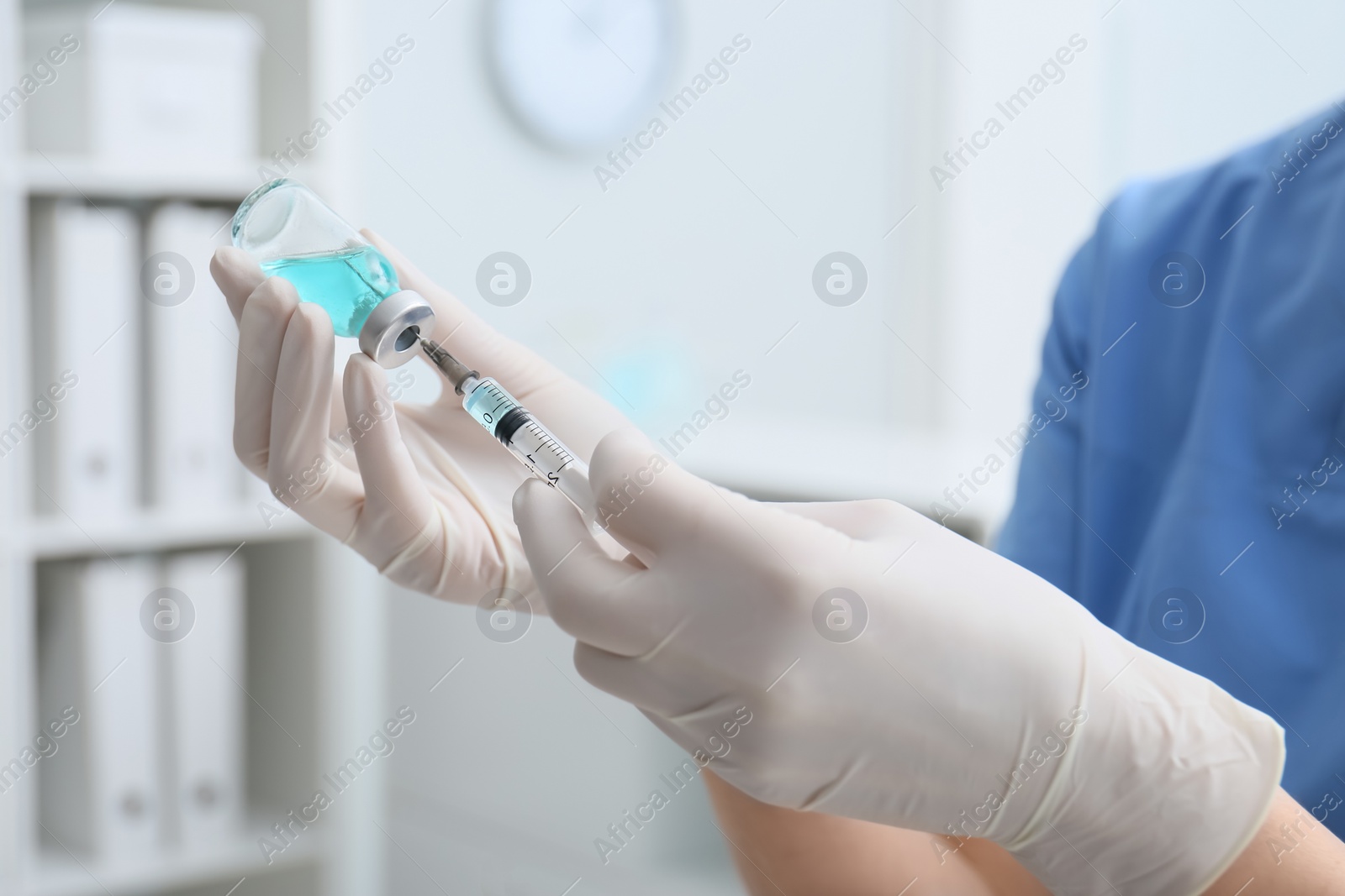 Photo of Doctor filling syringe with medication from vial in hospital, closeup