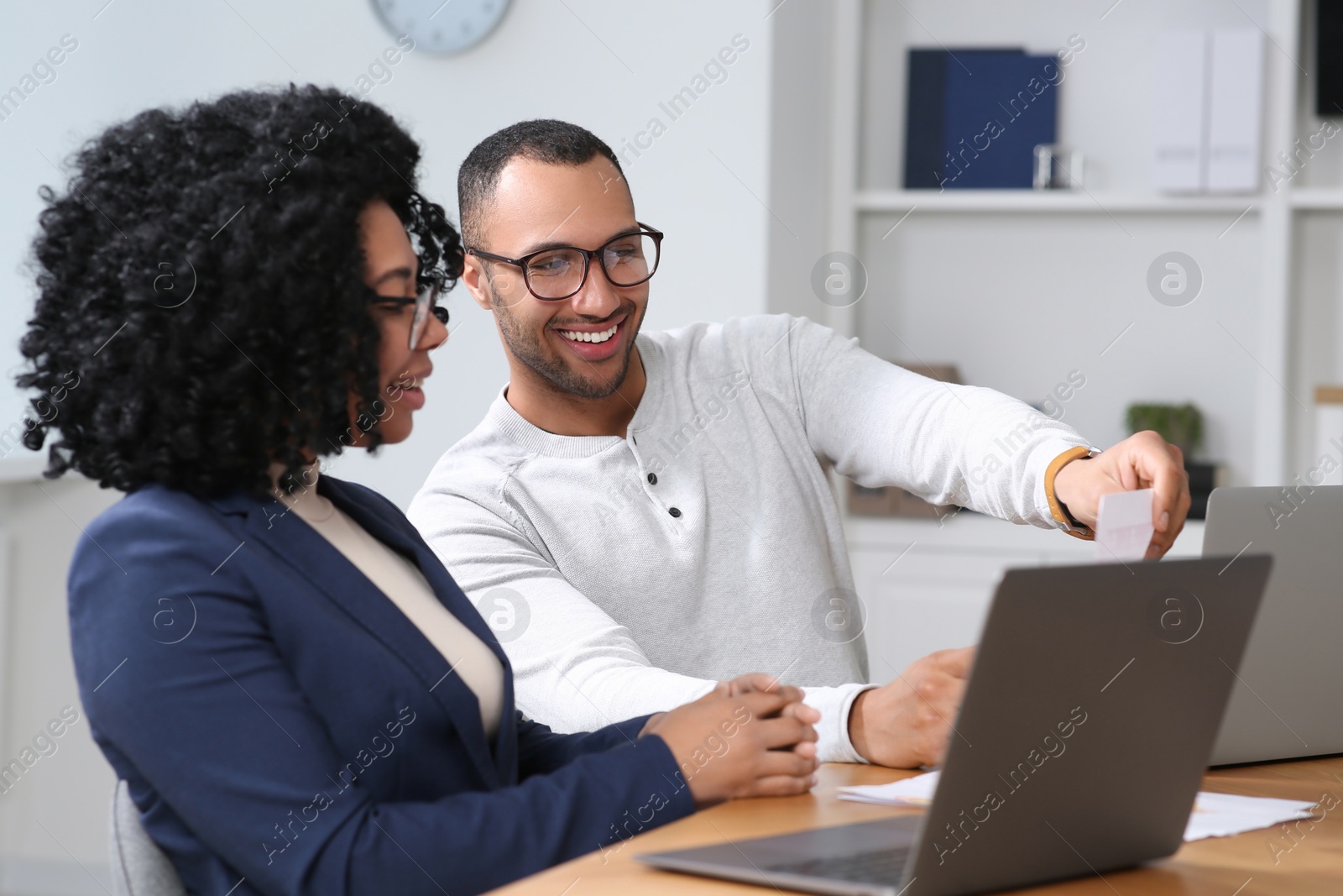 Photo of Young colleagues working together at table in office