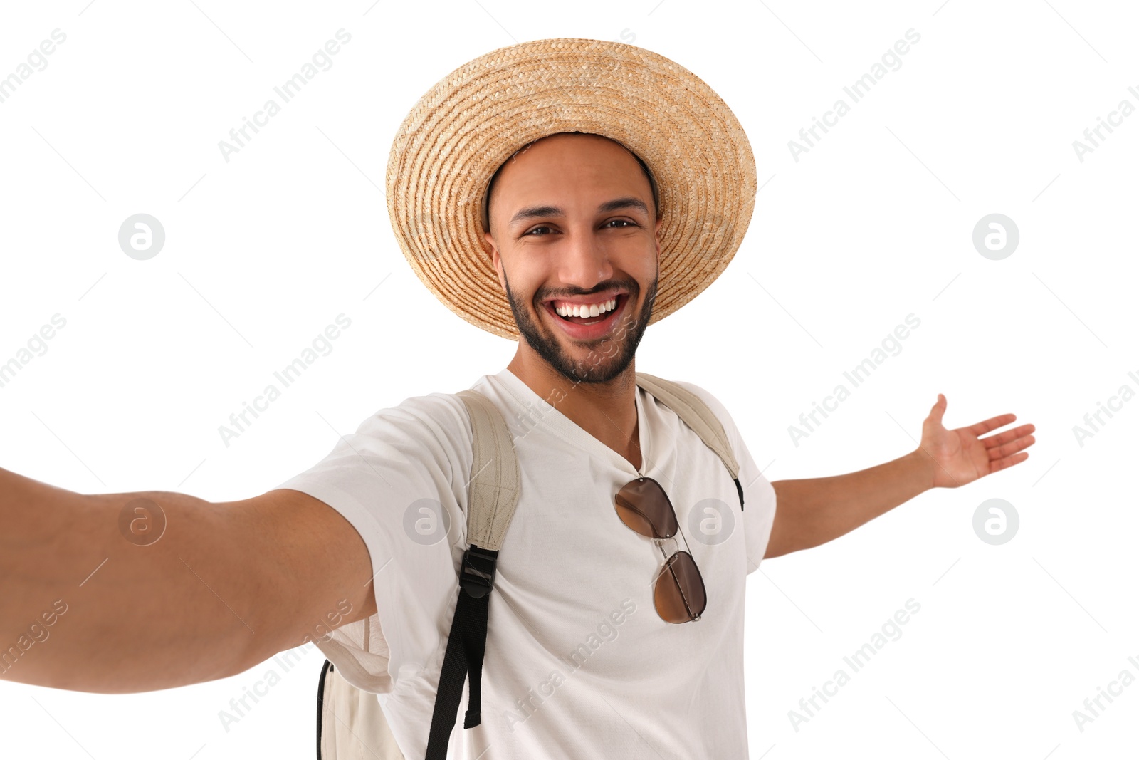 Photo of Smiling young man in straw hat taking selfie on white background